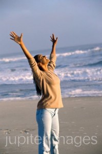Mid adult woman stretching on the beach